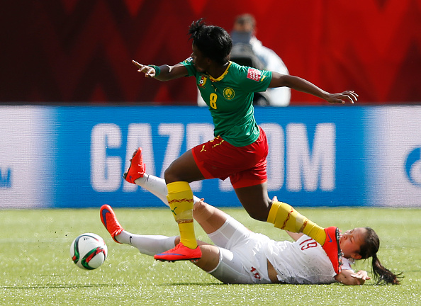 EDMONTON, AB - JUNE 20: Tan Ruyin #19 of China gets knocked over by Raissa Feudjio #8 of Cameroon during the FIFA Women's World Cup Canada Round 16 match between China and Cameroon at Commonwealth Stadium on June 20, 2015 in Edmonton, Alberta, Canada.  (Photo by Todd Korol/Getty Images)