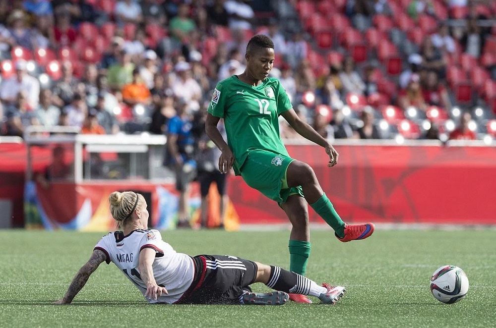 Germany's Anja Mittag tackles Ivory Coast's Ida Guehai  during a Group B match at the 2015 FIFA Women's World Cup at Landsdowne Stadium in Ottawa on June 7, 2015.    AFP PHOTO/NICHOLAS KAMMNICHOLAS KAMM/AFP/Getty Images ORG XMIT: 528449131